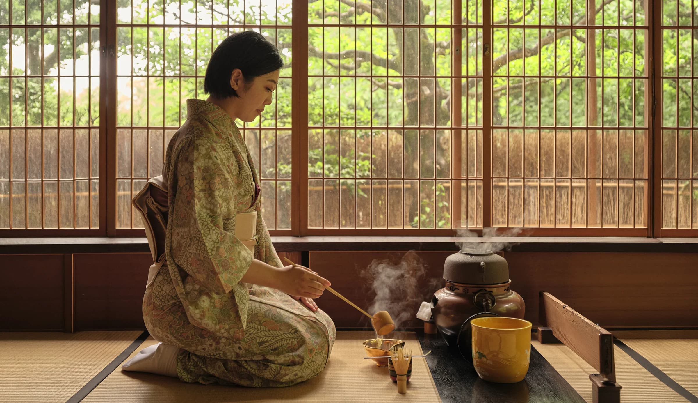 Woman in traditional Japanese clothing preparing tea