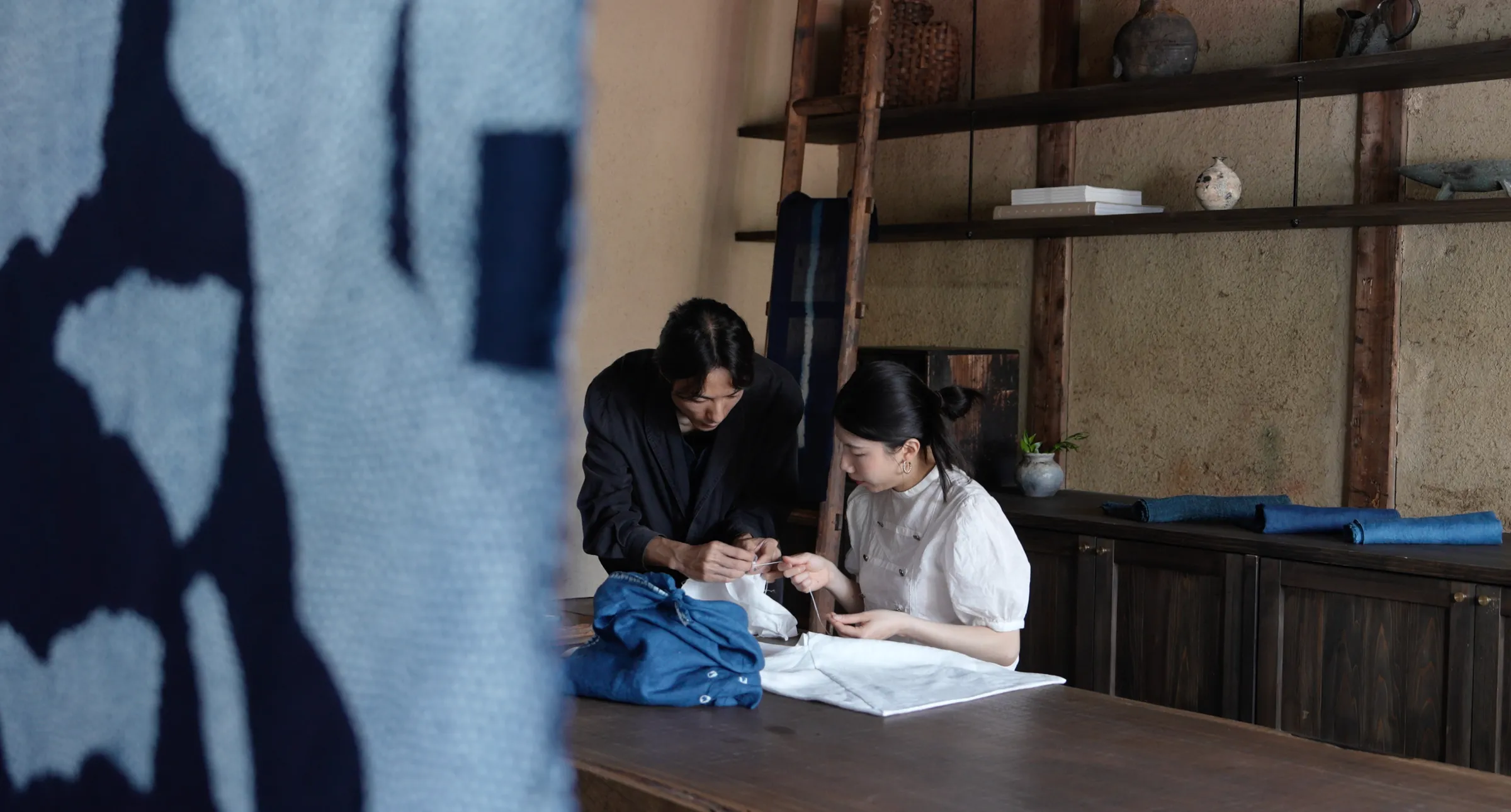 Indigo shibori textile with fine stitched pattern