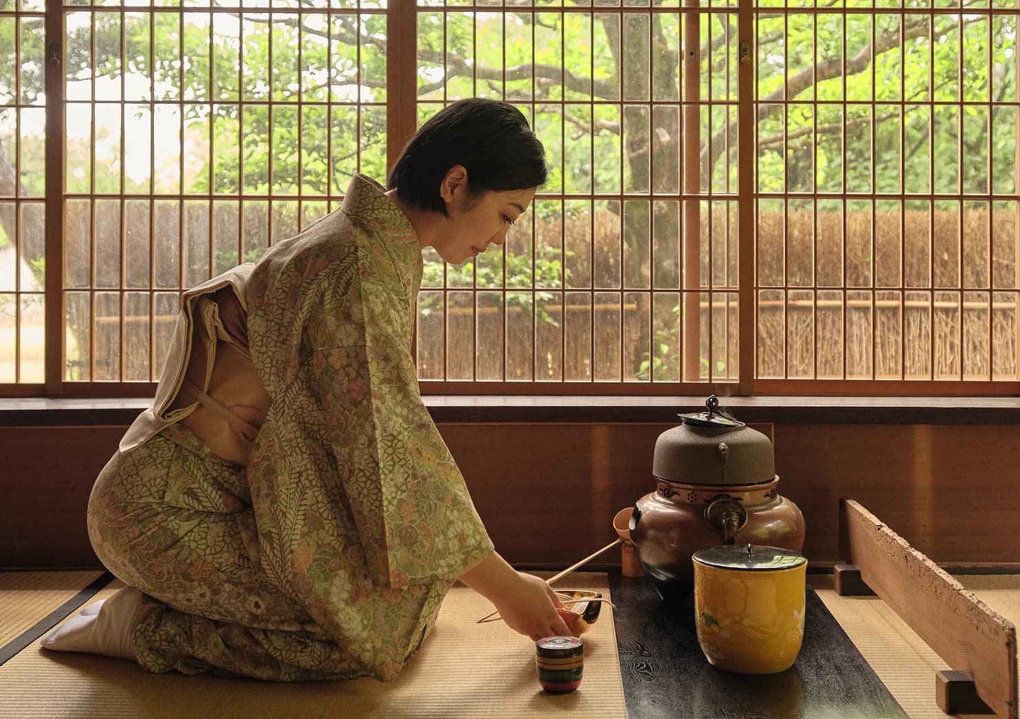 Woman making tea in a Japanese room