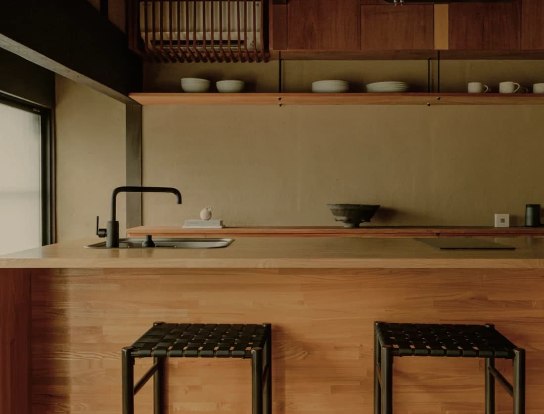 Urushi-lacquered kitchen island with wooden counter and pendant light