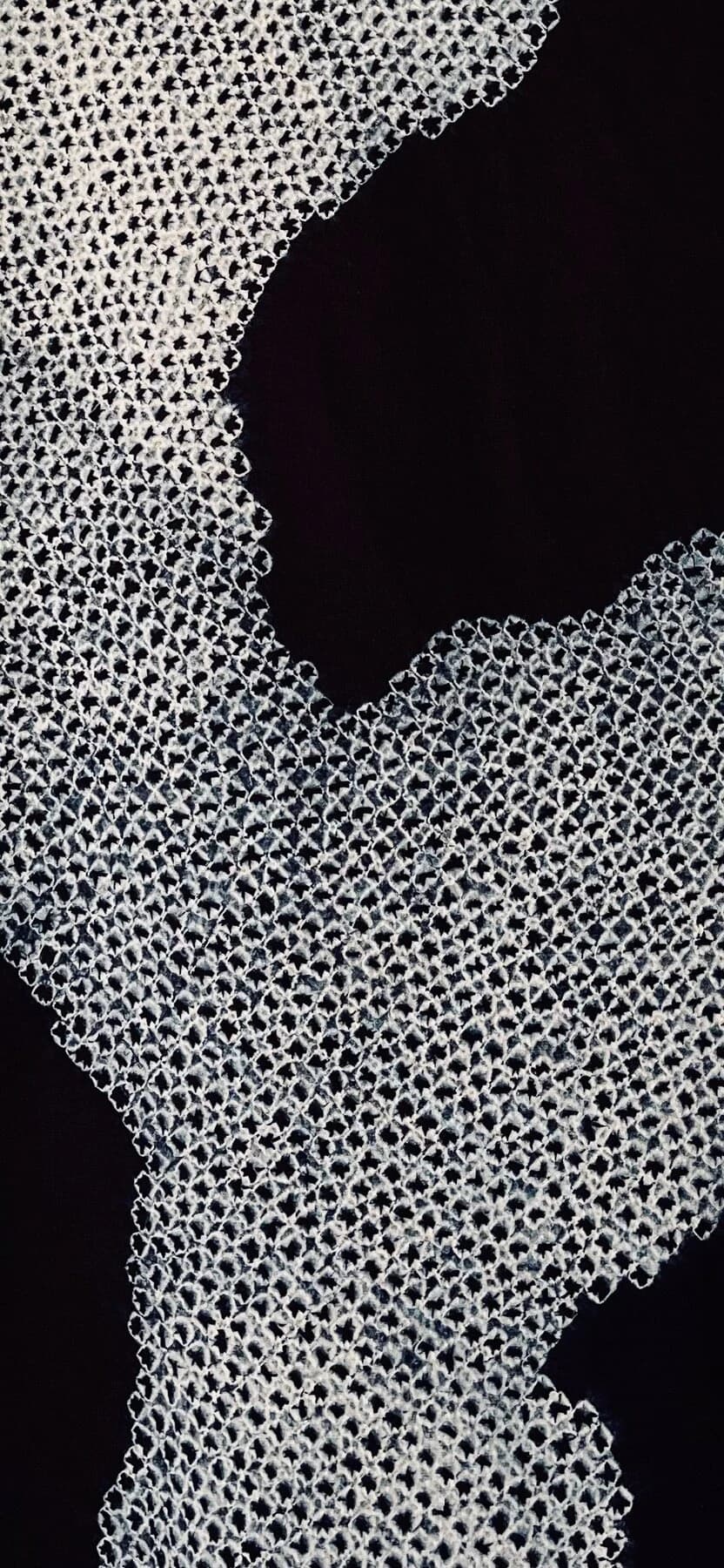 Indigo shibori textile with fine stitched pattern