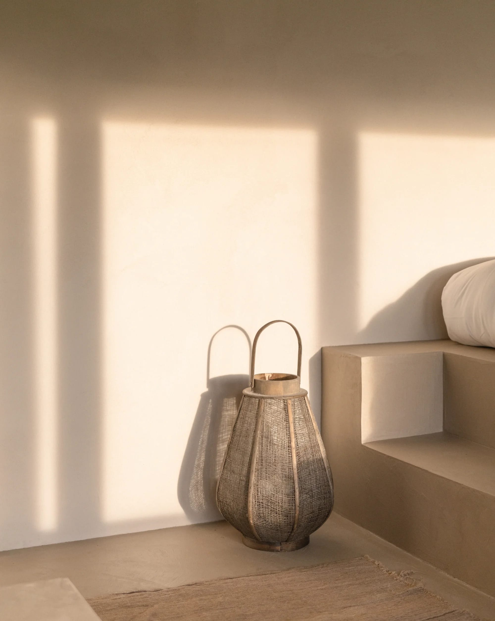 Woven lantern beside the bed in Suite 1